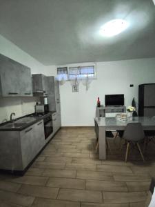 a kitchen with a table and a kitchen with a dining room at Residenza Mazzini in Avezzano +12 photos