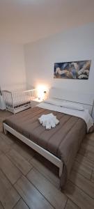 a large bed in a white room with a white at Residenza Mazzini in Avezzano
