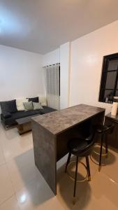 a living room with a table and two stools at Mabini Homestay in Mabini