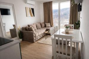 a living room with a couch and a table at Green panorama Vrdnik in Vrdnik