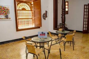 a room with two tables and chairs and a window at SGH Hotel San Agustin in Santa Marta