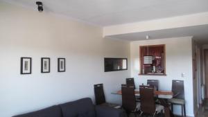 a living room with a couch and a table at Departamento Duplex Centro Pucon in Pucón