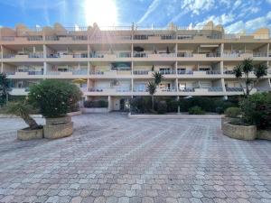 a large building with palm trees in front of it at L'Original in Hyères