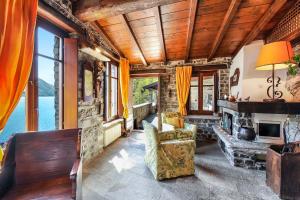 a living room with a couch and a fireplace at La Torre Di Porlezza in Porlezza