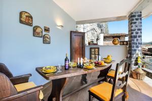 a dining room with a table with food on it at La Torre Di Porlezza in Porlezza +14 photos