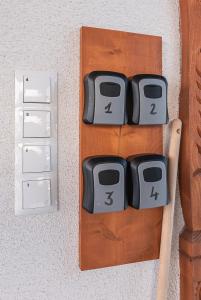 two electrical switches on a wall next to a table at Apartamenty Baj na Polnej - bezpłatny parking, widok na góry i zewnętrzna balia! in PyzÃ³wka +89 photos