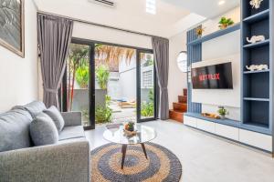 a living room with a couch and a table at Manik Tropicana Loft in Canggu