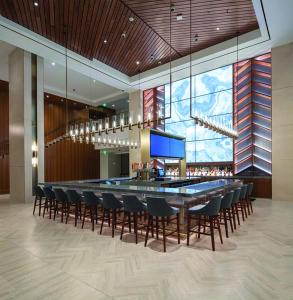 a bar in a hotel with chairs and a table at Harrah's Cherokee Casino Resort - A Caesars Rewards Destination in Cherokee +66 photos