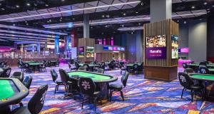 a poker room with tables at Harrah's Cherokee Casino Resort - A Caesars Rewards Destination in Cherokee