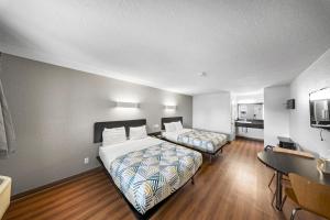 a hotel room with two beds and a kitchen at Motel 6-Moultrie, GA in Moultrie