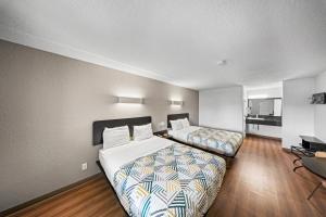 a hotel room with two beds and a desk at Motel 6-Moultrie, GA in Moultrie