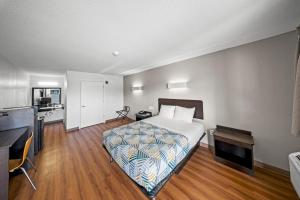 a hotel room with a bed and a kitchen at Motel 6-Moultrie, GA in Moultrie