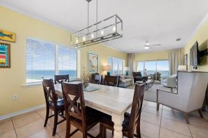 a dining room and living room with a table and chairs at Marlin Key 4G by Youngs Suncoast in Orange Beach