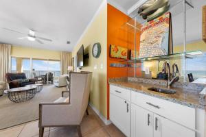 a kitchen with a sink and a living room at Marlin Key 4G by Youngs Suncoast in Orange Beach