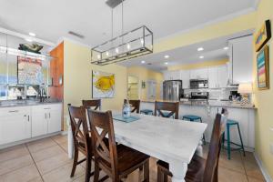 a kitchen and dining room with a table and chairs at Marlin Key 4G by Youngs Suncoast in Orange Beach