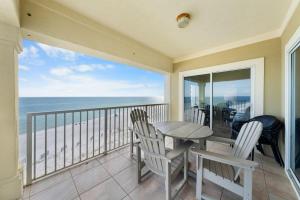 a balcony with a table and chairs and the ocean at Marlin Key 4G by Youngs Suncoast in Orange Beach