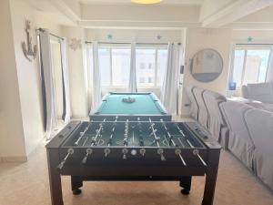 a pool table in the middle of a room at Las Palmas 4BR 4BA Penthouse Ocean View 703 in Campo del Medio