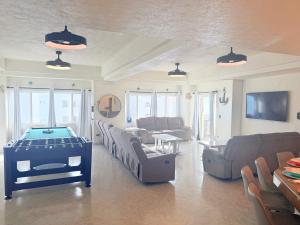 a living room with a pool table in it at Las Palmas 4BR 4BA Penthouse Ocean View 703 in Campo del Medio