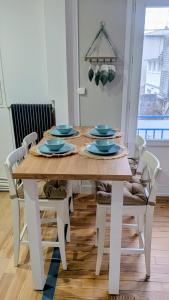 a dining room table with blue dishes on it at Le Saint-Georges in Berck-sur-Mer +19 photos