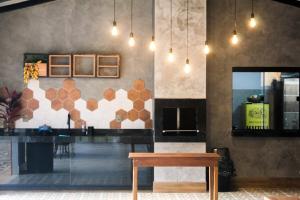a dining room with a table and a counter at Chalé São Bernardo, Carmo RJ in Carmo