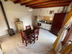 a kitchen with a table and chairs in a room at Balcones del Pintor in Maimará +17 photos