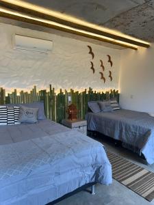 two beds in a bedroom with birds on the wall at Chalé São Bernardo, Carmo RJ in Carmo +29 photos
