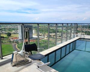 a balcony with a chair and a swimming pool at Condomínio Residencial - Hype 017 | by Housi in Sao Jose do Rio Preto +241 photos