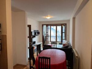 a room with a table and a living room with a window at Kolasin Rent Apartment in Kolašin