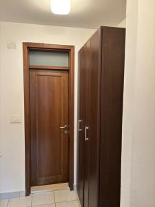 a wooden door in a room with at Kolasin Rent Apartment in Kolašin