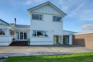 a large white house with a driveway at Delight On Dalton in Hokitika