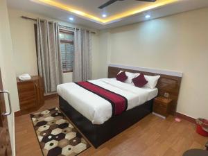 a bedroom with a large bed in a room at New milan guest house in Kathmandu