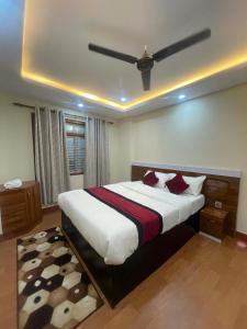 a bedroom with a large bed with a ceiling at New milan guest house in Kathmandu