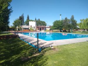a large swimming pool with a fence around it at Departamentos Valle de los Andes in San Rafael