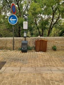 a bunch of signs on a brick street at Le Doudou, Charmant T2 avec Terrasse et Climatisation in Marmande