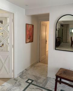 a hallway with a door and a mirror on a wall at Casaflor Tunis in Tunis