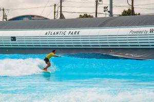 a person riding a wave on a surfboard in the water at Barclay Cottage Inn in Virginia Beach