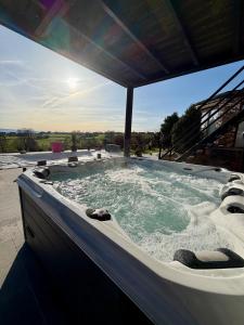 a jacuzzi tub on a patio with the sun in the background at Studio 94 in Welkenraedt