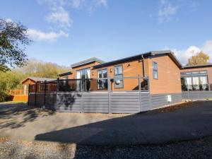a large house with a fence in front of it at 7 Lake View in Windermere