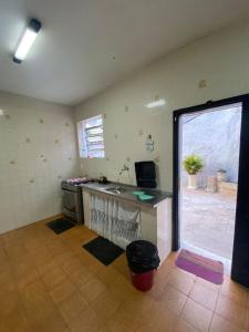 a kitchen with a counter and a sink in a room at Pousada Por do Sol in Teresópolis