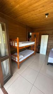 a room with two bunk beds in a cabin at canto da lagoa in Garopaba