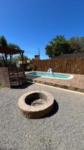 a brick oven in a yard with a swimming pool at canto da lagoa in Garopaba