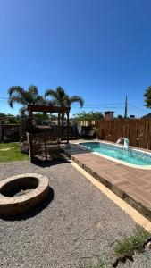 a swimming pool with a gazebo and a swimming pool at canto da lagoa in Garopaba