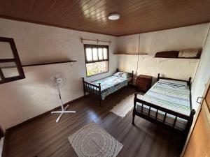 an overhead view of a room with two beds and a fan at Eywa in Punta Del Diablo
