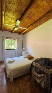 a bedroom with a large bed with a wooden ceiling at LA FACUNDA in San Francisco del Monte de Oro