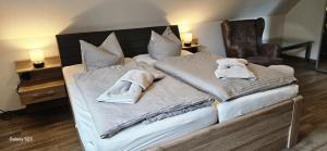 a bedroom with a bed with towels on it at Sternenhimmel in Lenz