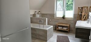 a bathroom with a tub and a sink at Sternenhimmel in Lenz