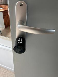 a close up of a door with a remote control at Chambre de charme dans maison coloniale in Noumea
