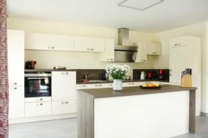 a kitchen with white cabinets and a counter top at Sonnenschein in Lenz