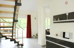 a living room with a staircase and a red curtain at Sonnenschein in Lenz