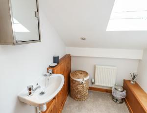 a bathroom with a sink and a mirror at Yr Orsedd in Holyhead +19 photos
